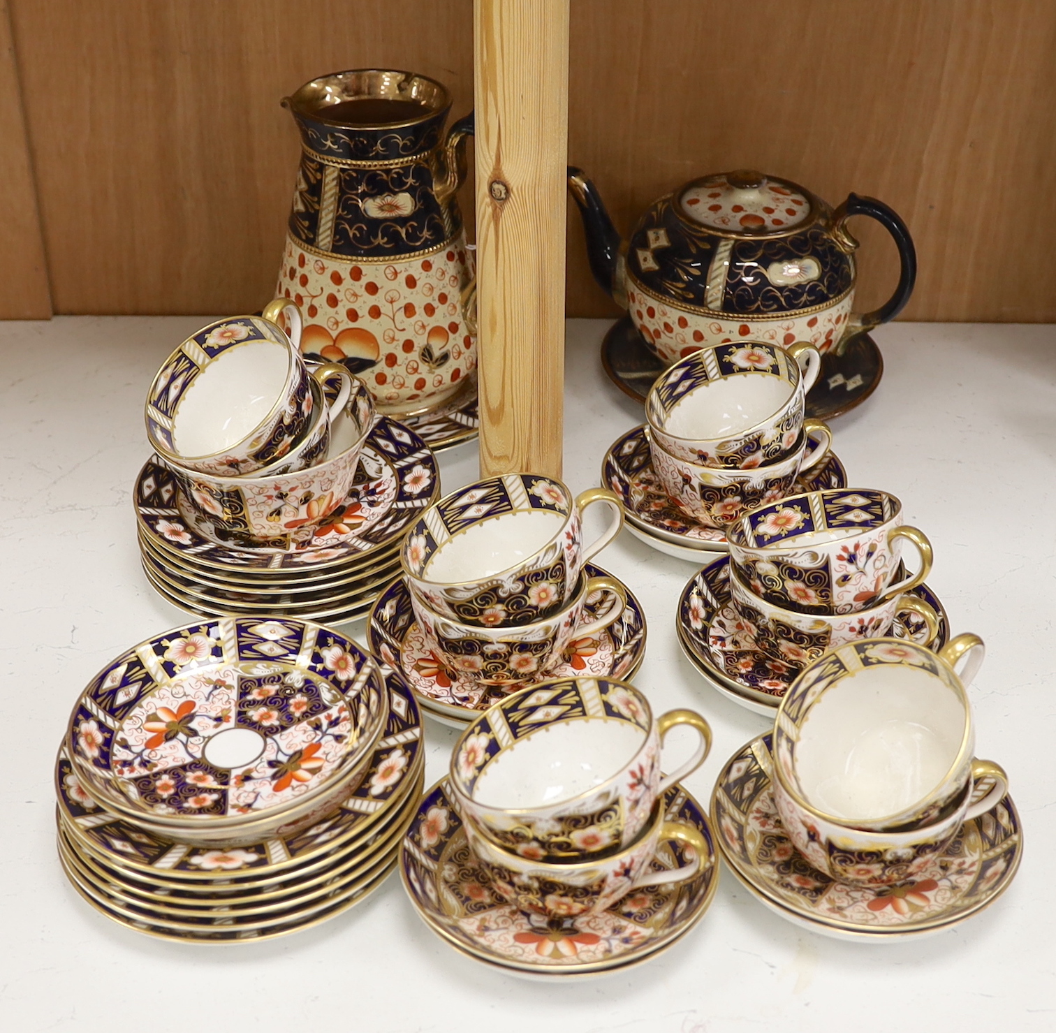 A Royal Crown Derby Imari pattern 2451 part tea set together with an Imari style jug, teapot and stand, largest 18cm high